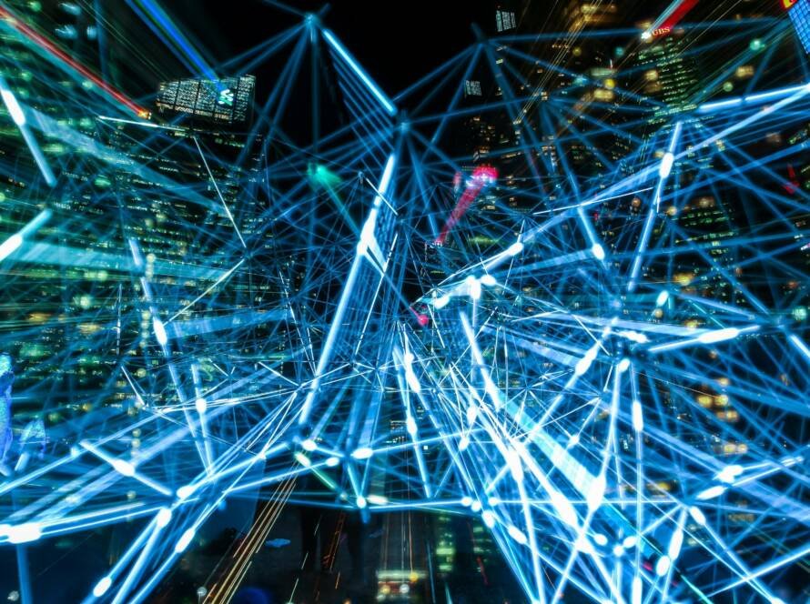 Digital network overlay across a city skyline, symbolizing artificial intelligence, automation, and connected systems in modern hospitality